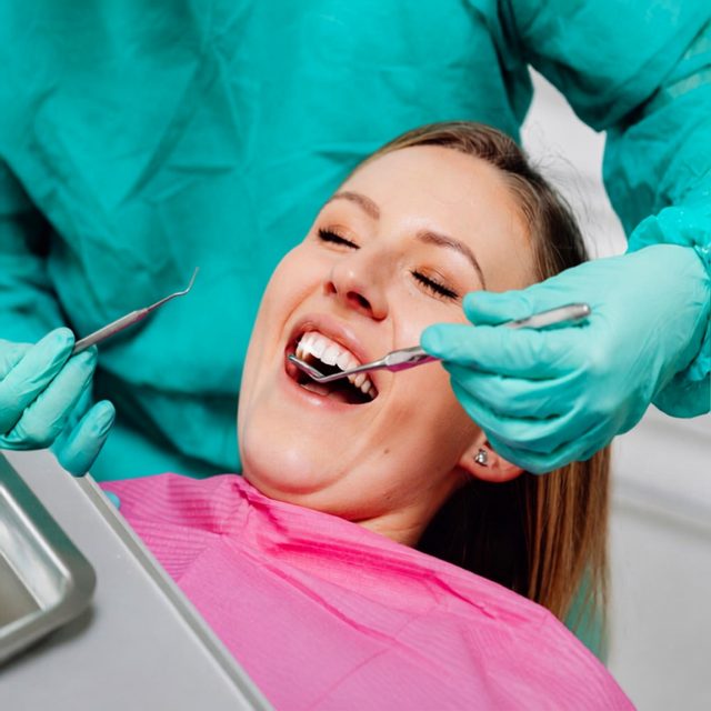 Dentist performing a comfortable tooth extraction procedure at Island Dentists